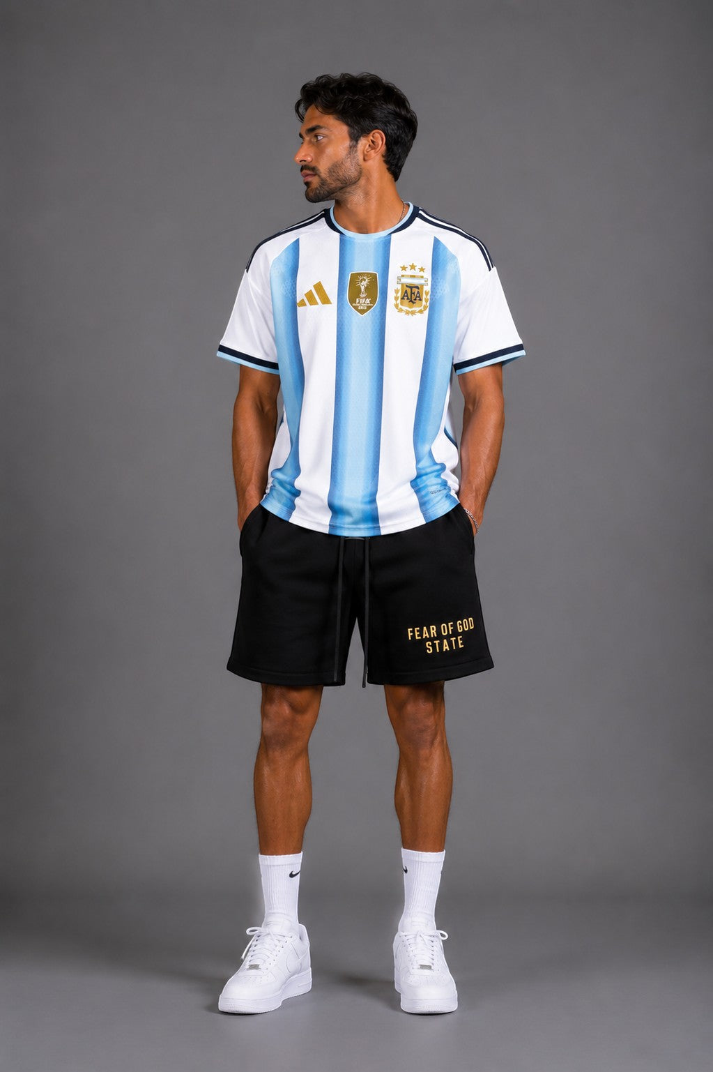 Hoopers sky blue and white striped Argentina soccer jersey with gold details. Model wears black shorts.