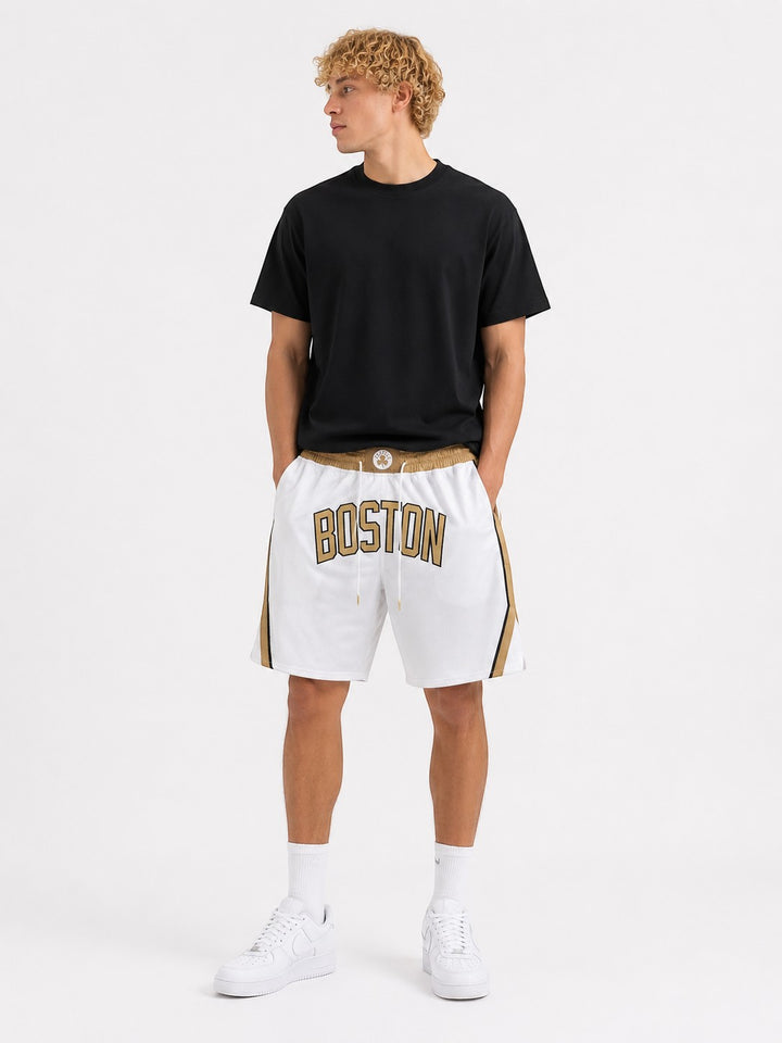 Hoopers white mesh basketball shorts with gold trim and "BOSTON" text, featuring a comfortable fit and classic NBA style.