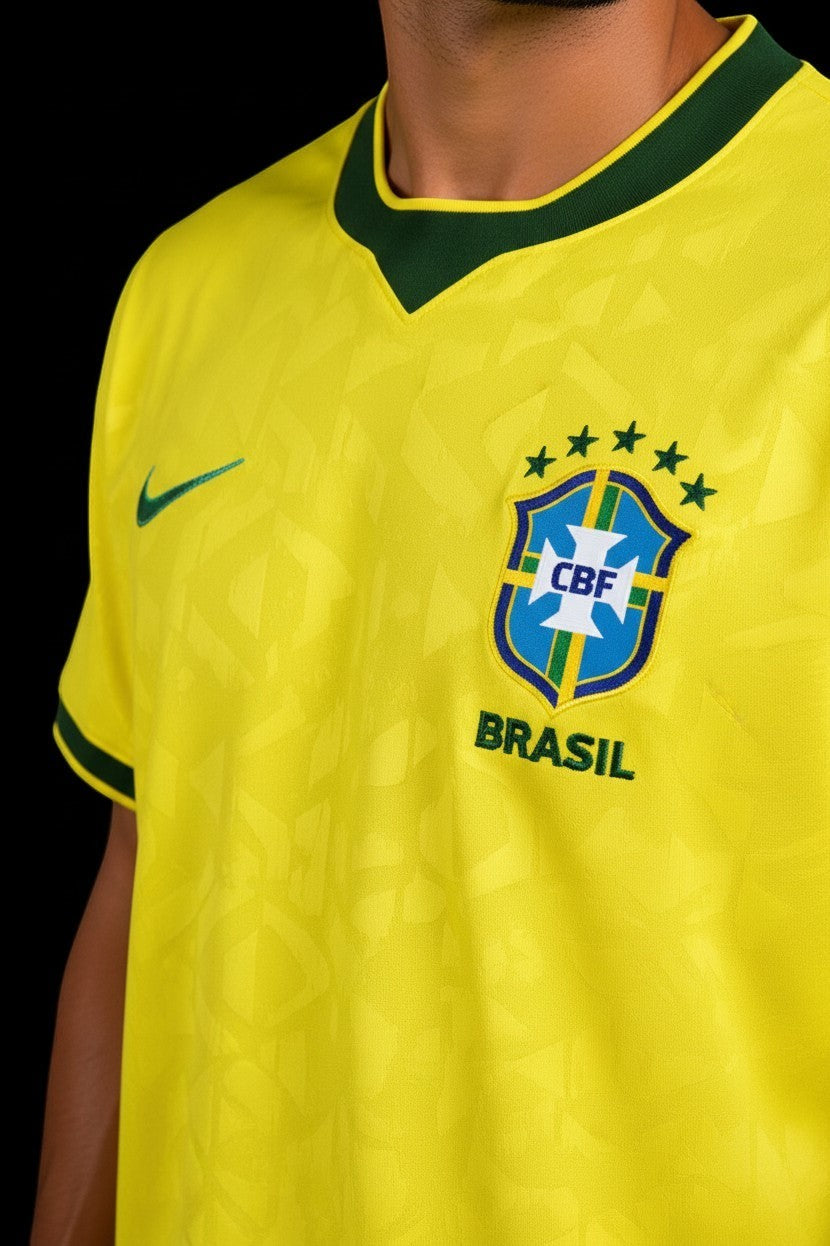 Hoopers yellow Brazil World Cup football jersey with green trim and subtle geometric pattern. Features CBF crest and "BRASIL" text.