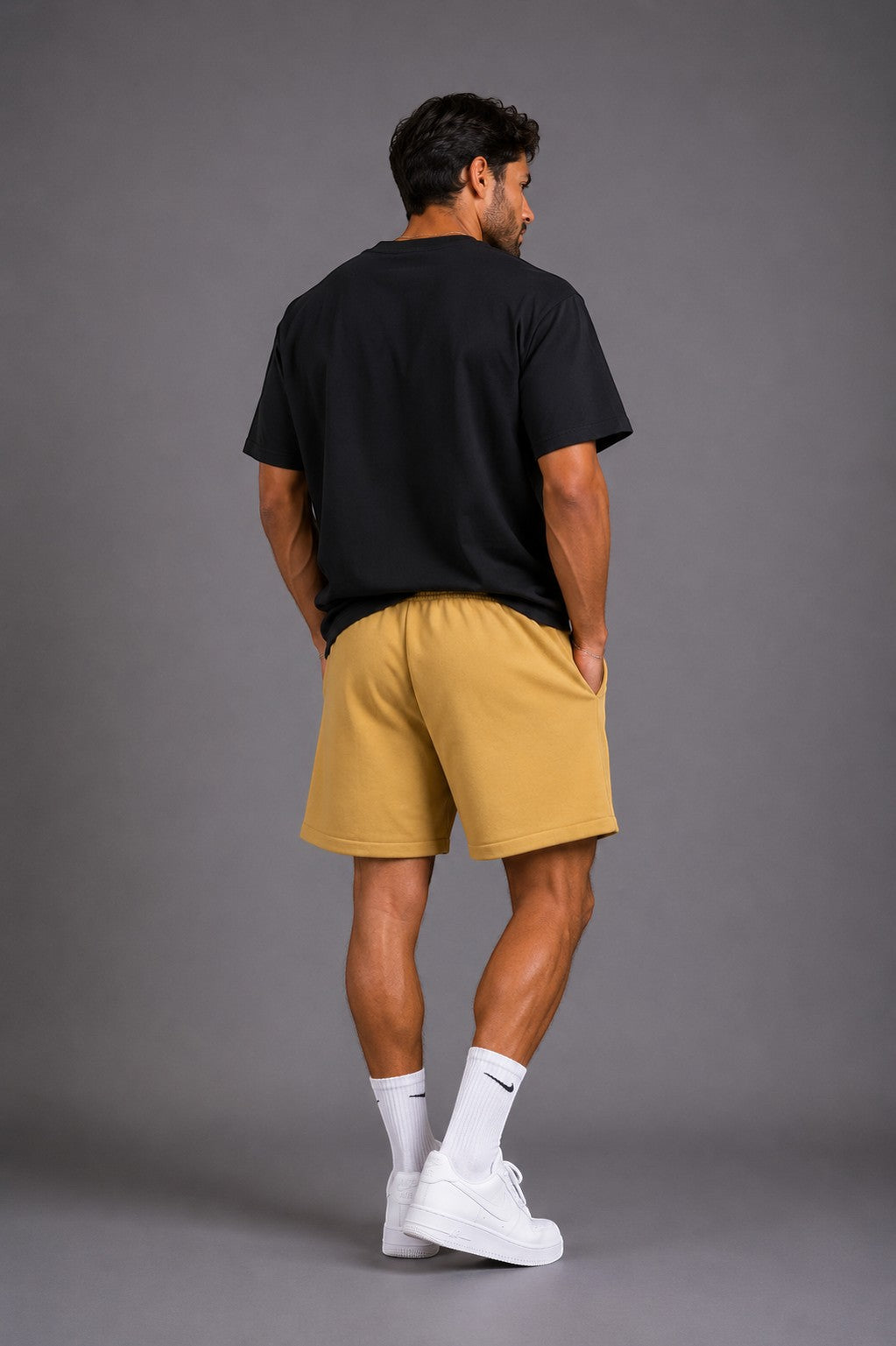 Hoopers Desert Sand yellow shorts with drawstring and side pockets, relaxed fit, on a male model.