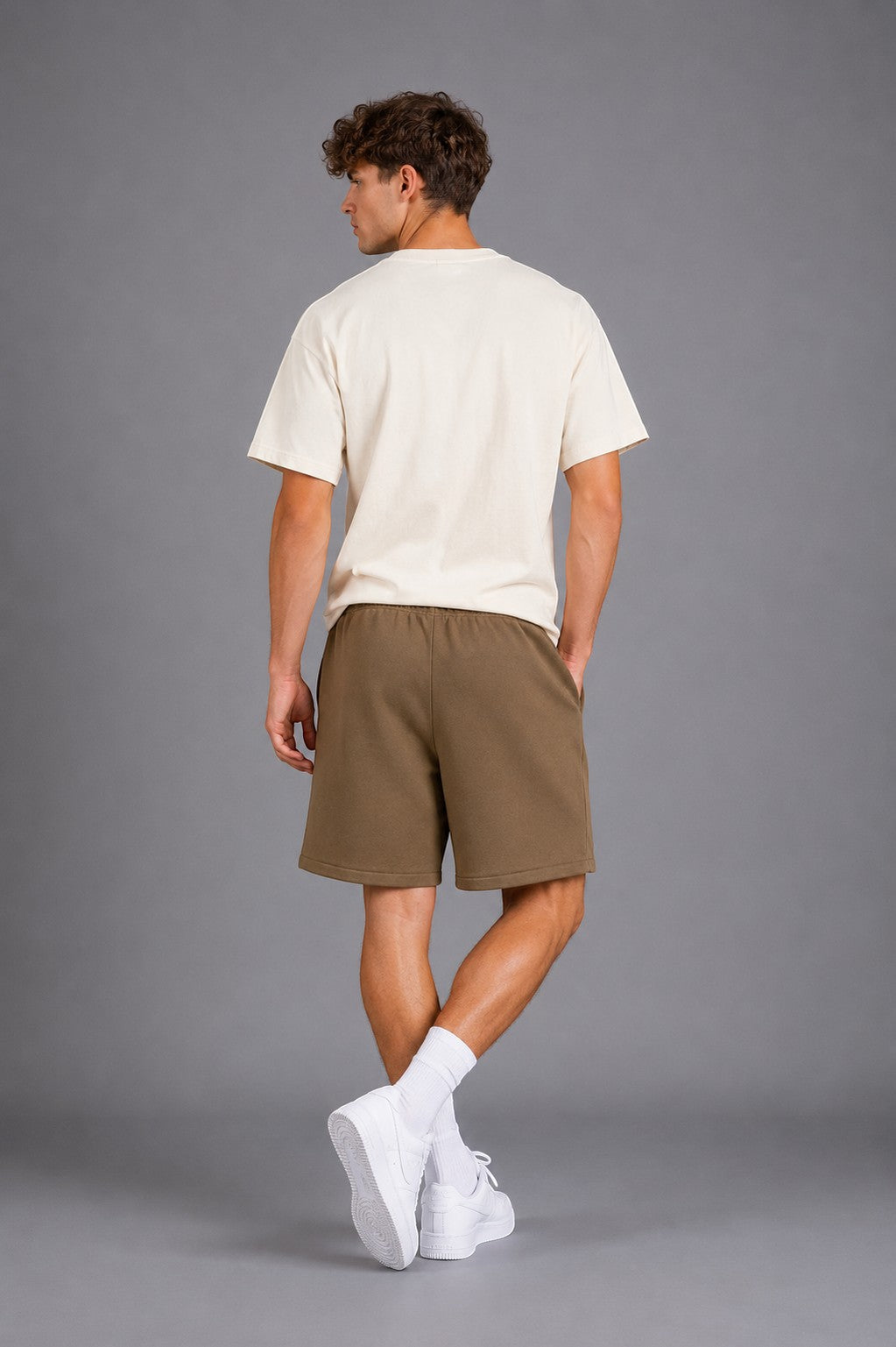 Hoopers Fear Of God Desert State olive khaki sweat shorts with drawstring and side pockets on a male model.