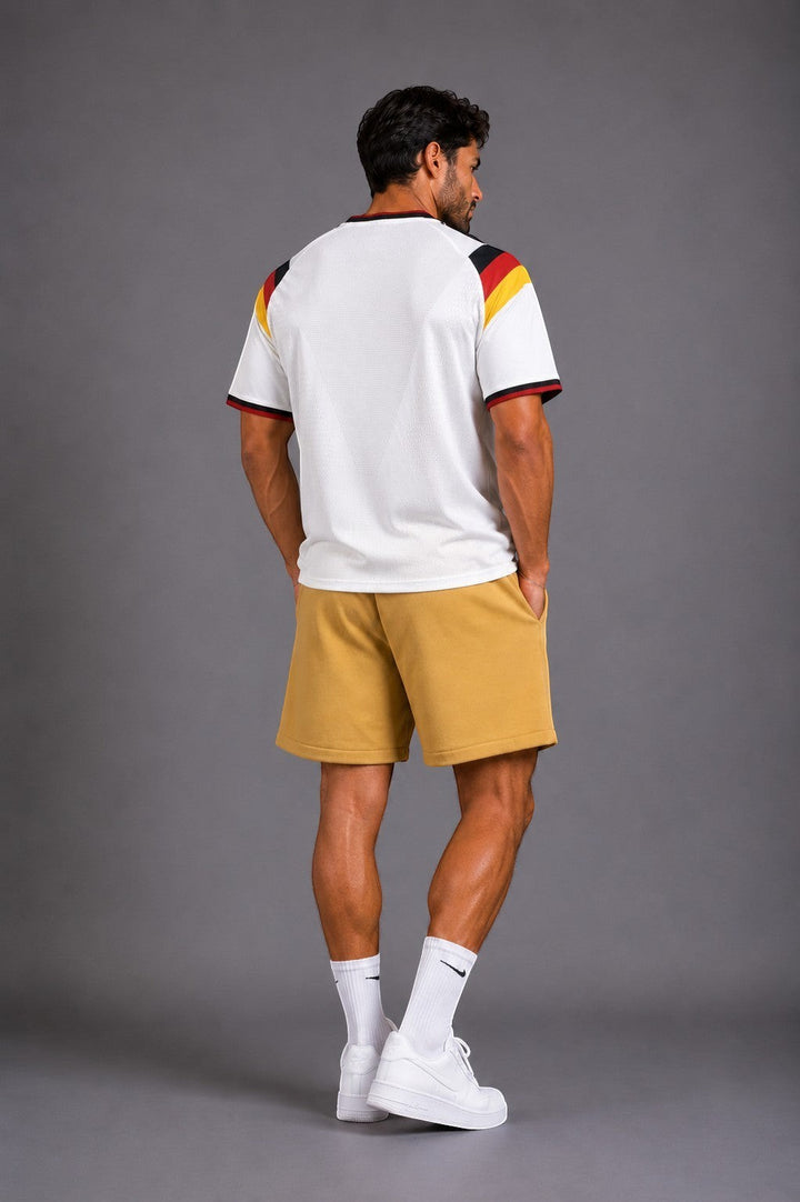 Hoopers white retro Germany football jersey with black, red, and yellow accents on sleeves and collar. Relaxed fit.