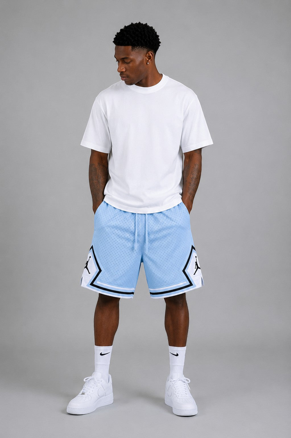 Hoopers Ice Blue Jordan basketball shorts with white and black trim, made of mesh material.