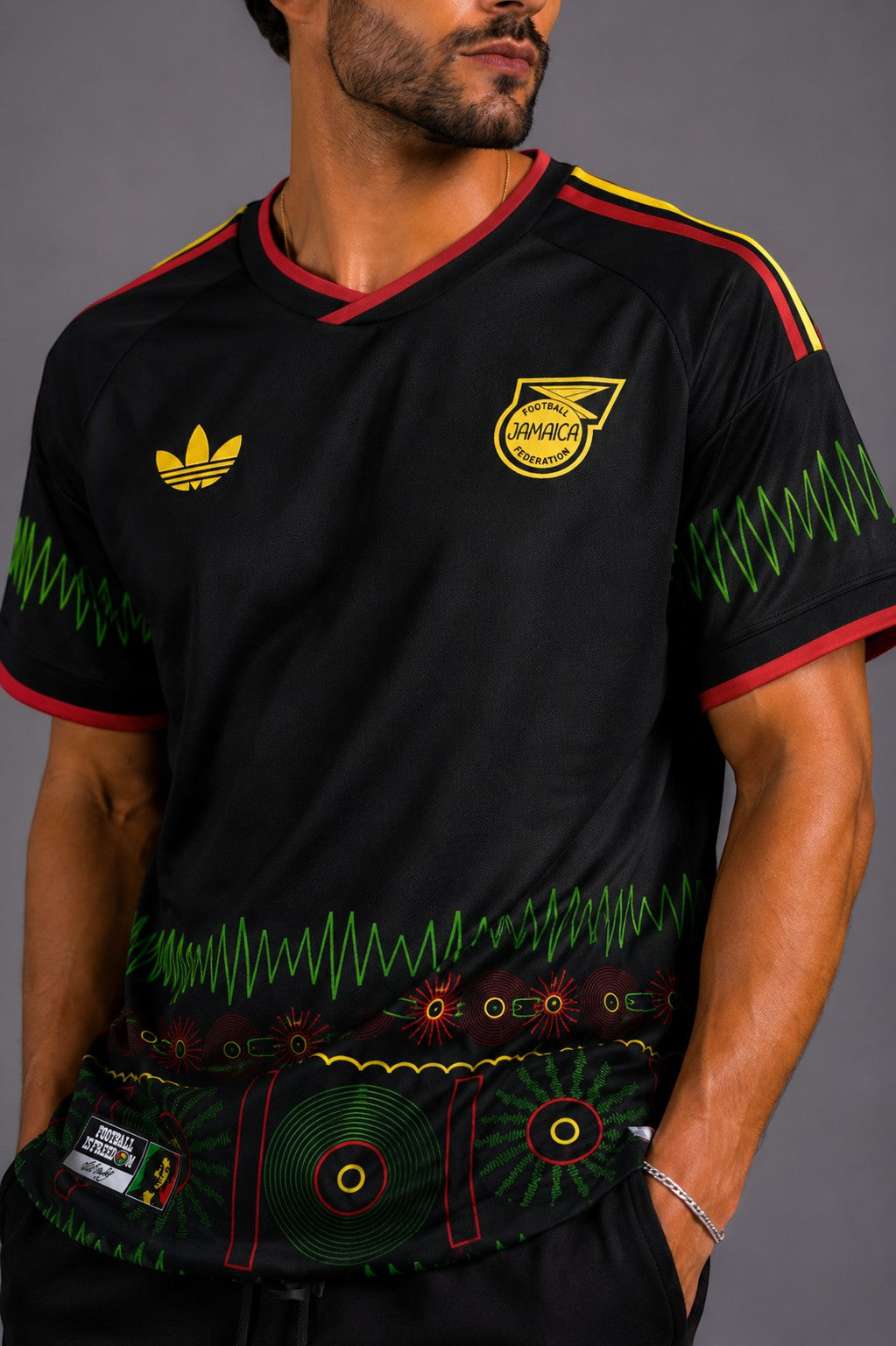 Hoopers black Jamaica World Cup Soundwave Edition jersey with red and yellow trim, featuring reggae-inspired graphics and a relaxed fit.