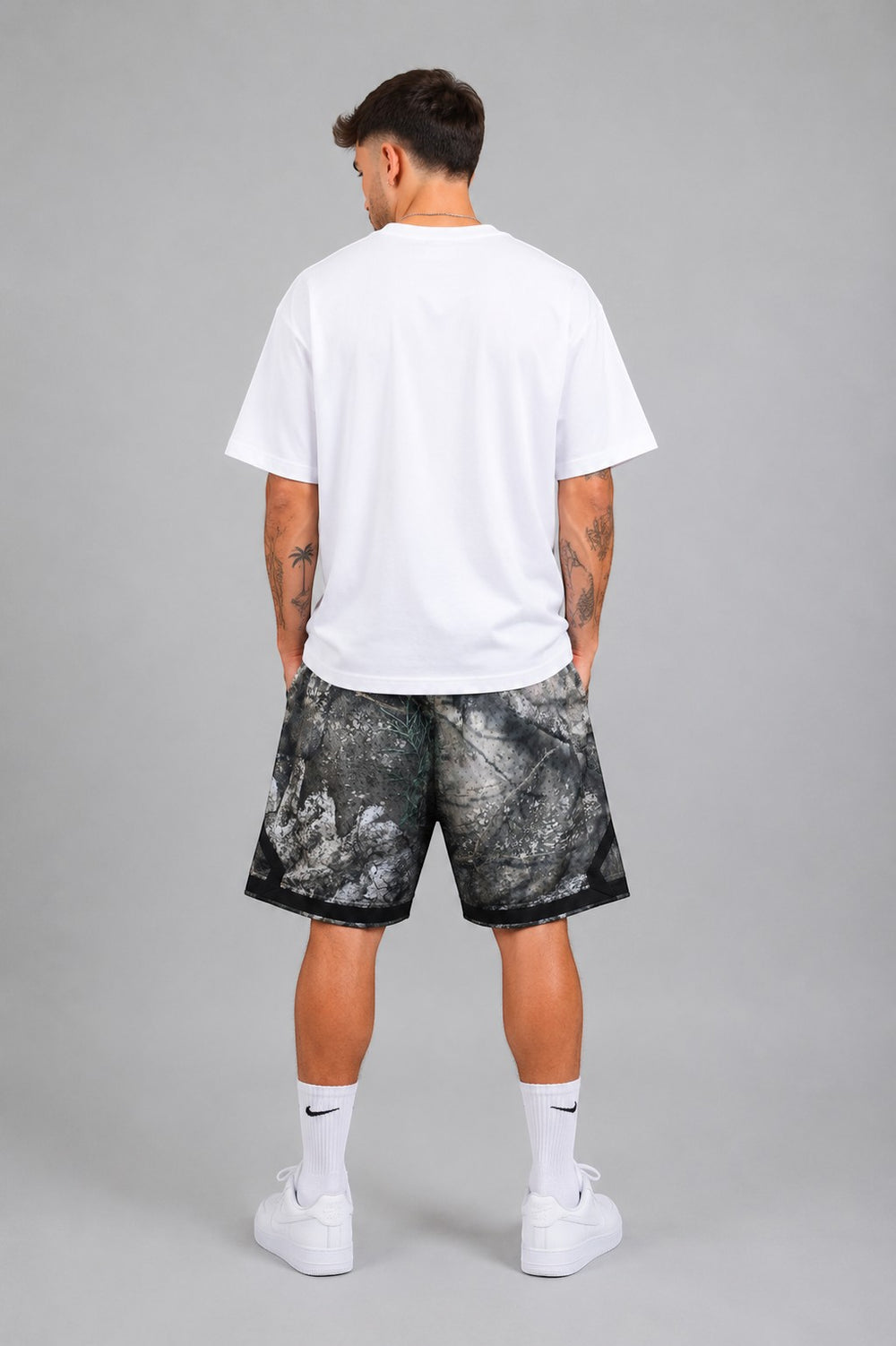 Hoopers Jordan Brand Woodland Camo shorts in grey, black, and stone. Loose fit, 100% polyester.