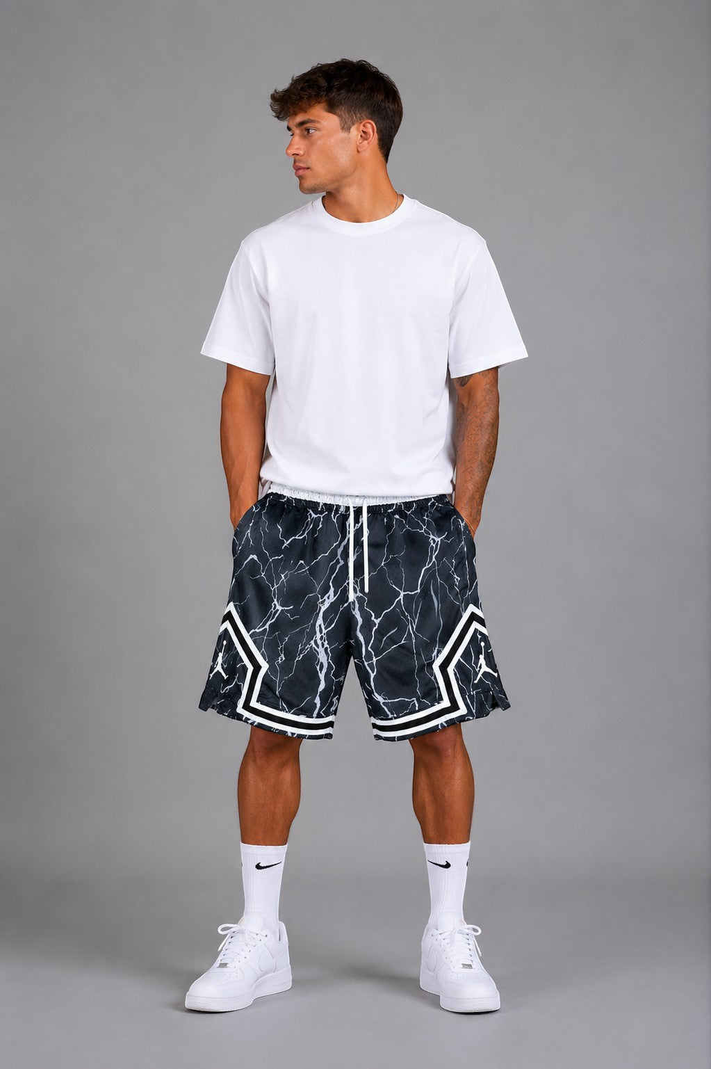 Hoopers Jordan Thunder Marble basketball shorts in black and white marble print with lightning details and white trim.