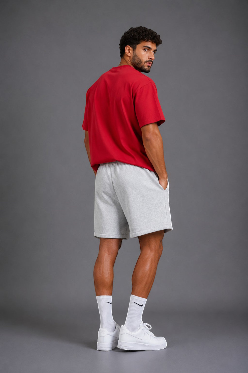 Hoopers light grey cotton blend sweat shorts with drawstring waist and side pockets. Model is wearing a red t-shirt.