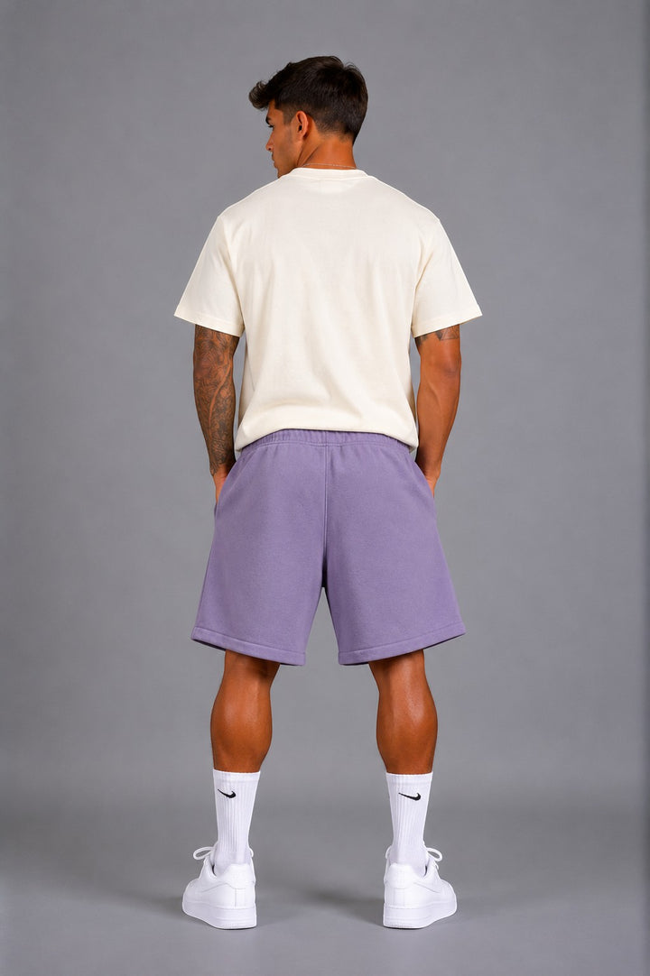 Hoopers lilac purple oversized sweat shorts with drawstring and side pockets, worn by a man.