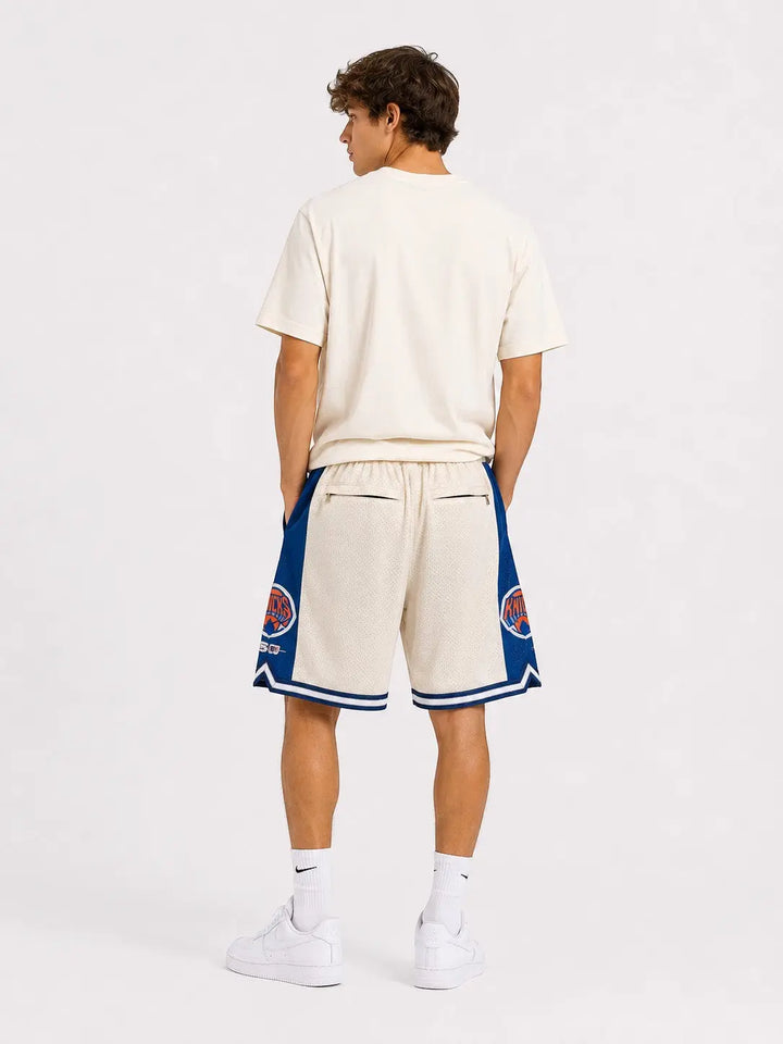 Hoopers New York Knicks retro basketball shorts in cream with blue and orange accents. Mesh fabric with embroidered logos.