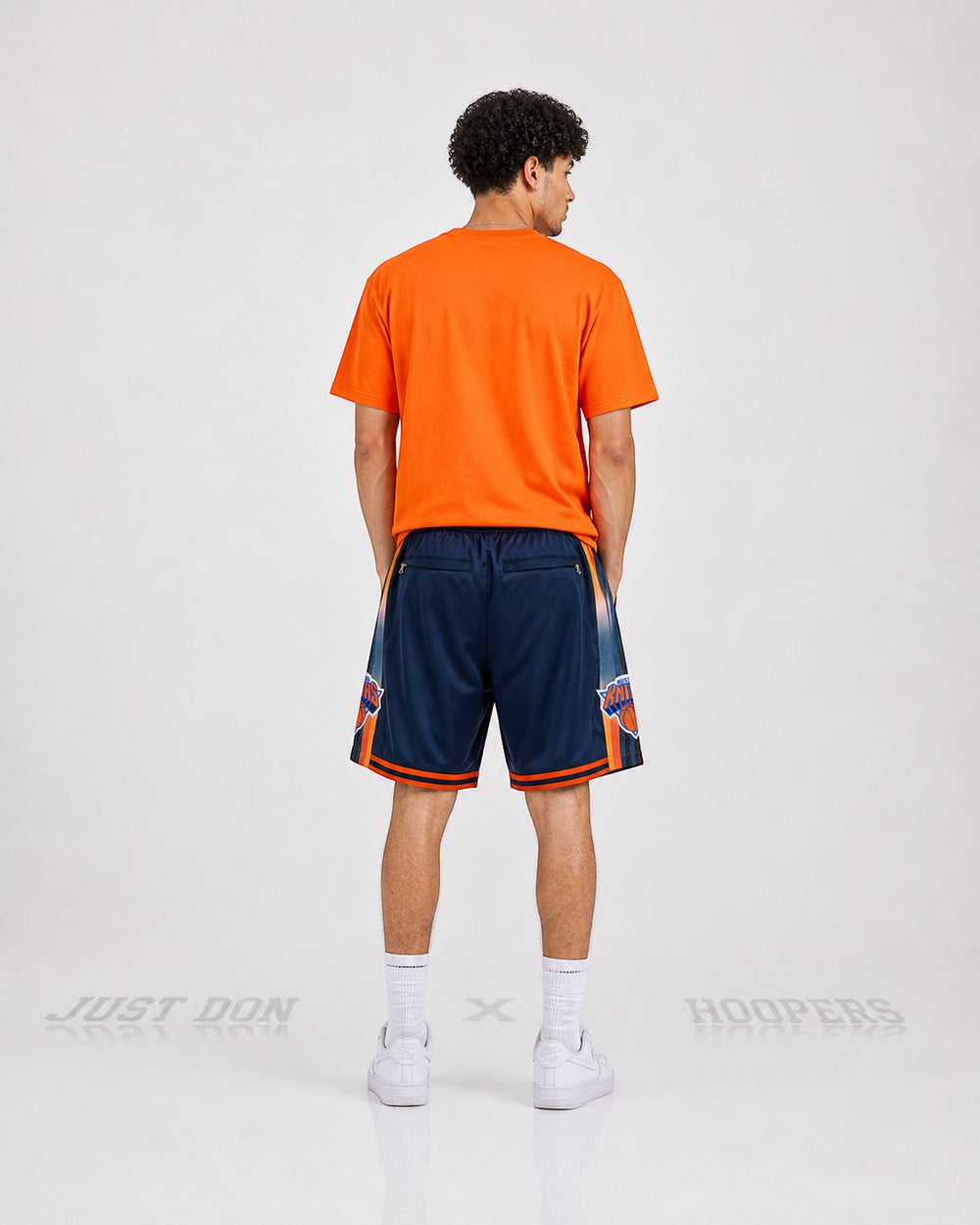 Hoopers navy and orange New York Knicks basketball shorts with side graphics and striped trim.