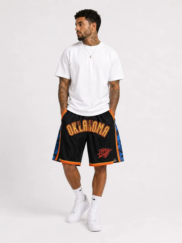 Hoopers black NBA shorts with Oklahoma City Thunder logo in blue and orange, wide basketball fit.