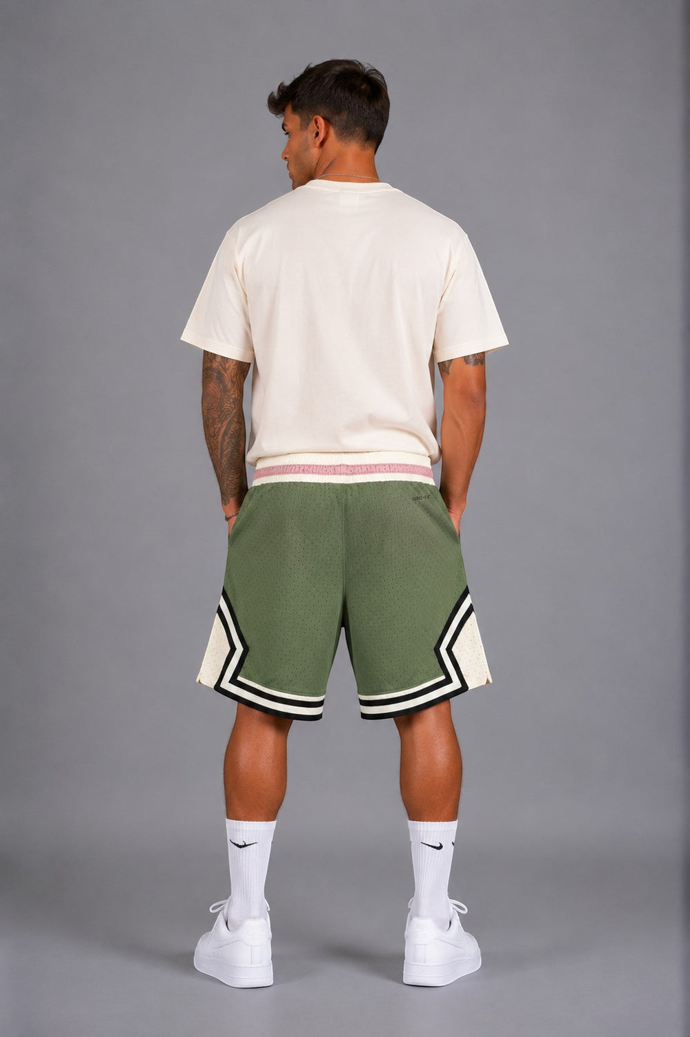 Hoopers men's olive green mesh basketball shorts with cream accents and pink waistband detail. Oversized fit.