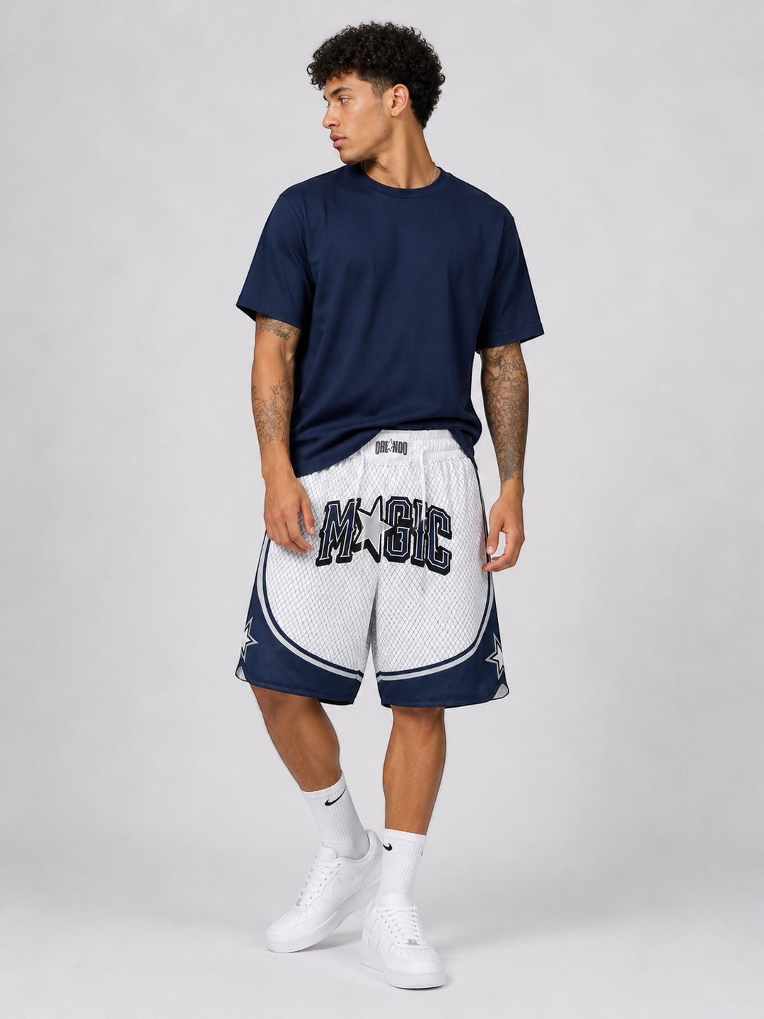Hoopers Orlando Magic retro basketball shorts in white and blue with mesh fabric and "MAGIC" lettering.