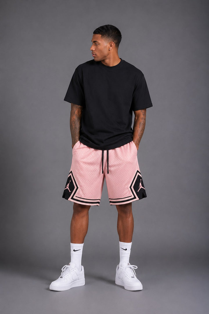 Hoopers men's pink mesh basketball shorts with black trim and Jordan logos. Relaxed fit, ideal for summer streetwear.