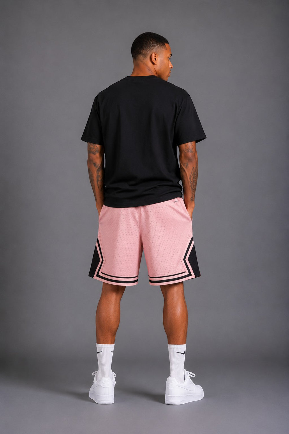 Hoopers men's pink mesh basketball shorts with black trim and Jordan logo. Relaxed fit.