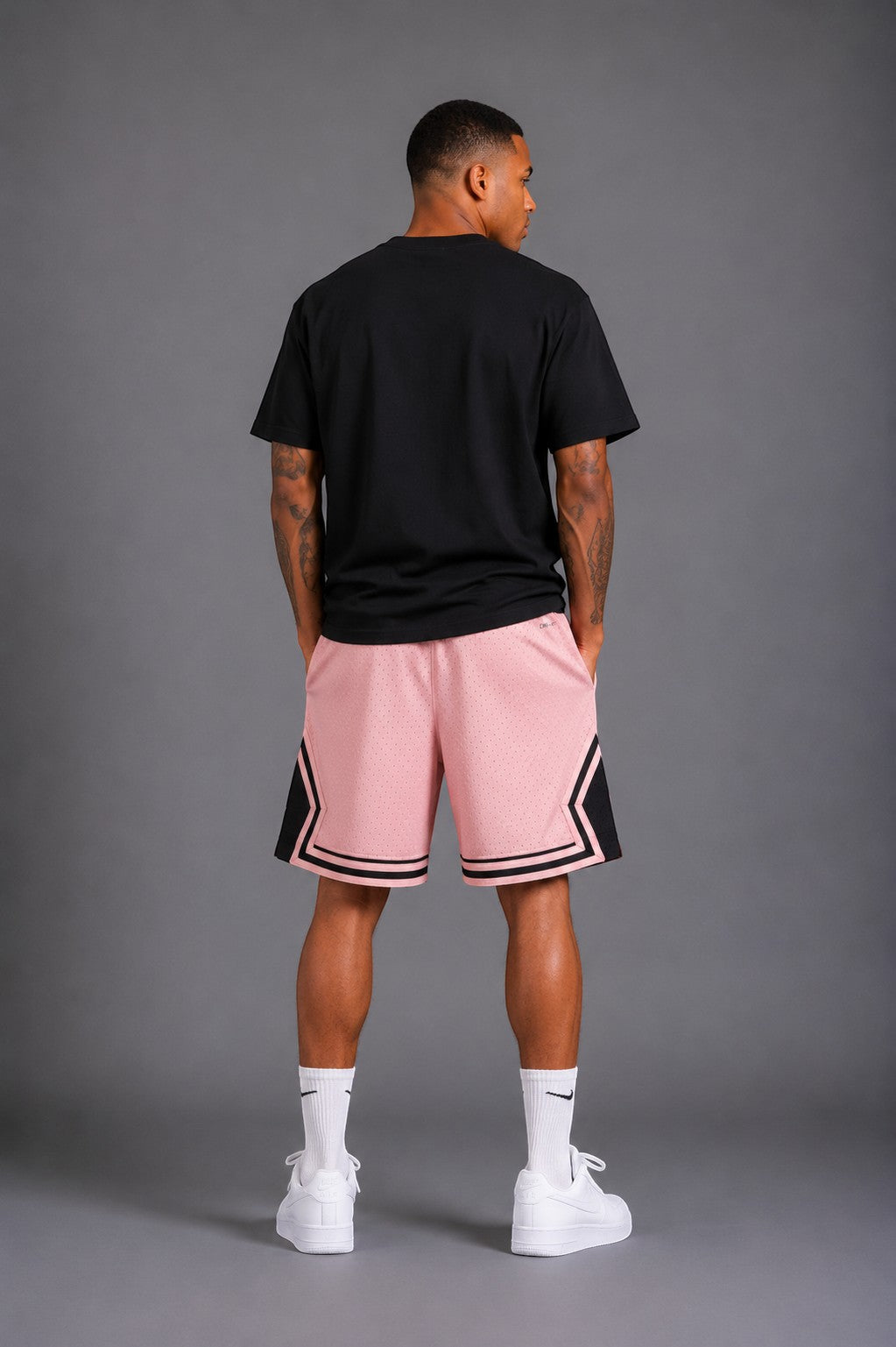 Hoopers men's pink mesh basketball shorts with black trim and Jordan logo. Relaxed fit.