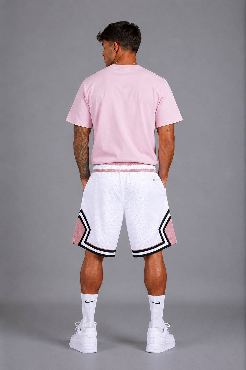 Hoopers men's white mesh basketball shorts with pink and black trim, featuring an oversized fit and Dri-FIT technology.