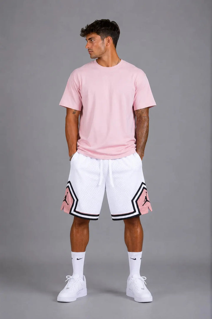 Hoopers men's white mesh basketball shorts with pink and black trim, featuring Jordan logo. Relaxed fit.