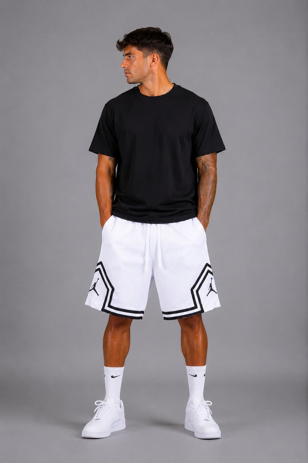 Hoopers men's white mesh basketball shorts with black trim and Jordan logo detail. Relaxed fit.